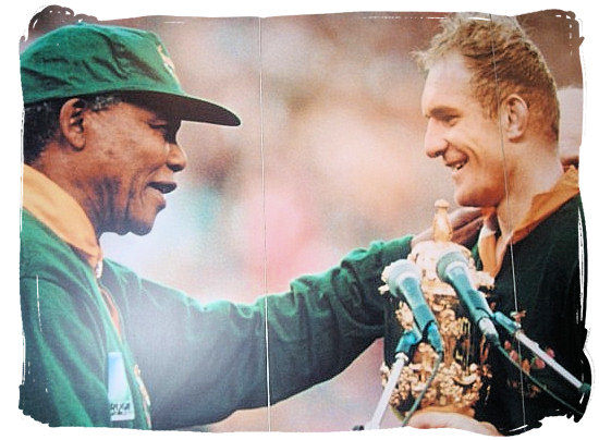 President Nelson Mandela congratulating Springbok captain Francois Pienaar, who is holding the William Webb Ellis Trophy - South Africa Rugby, Tri Nations Rugby and Super 14 Rugby