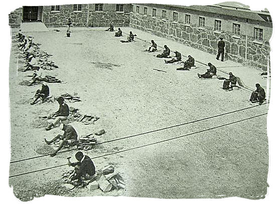 Hard labour by prisoners in the court yard of Robben Island prison, crushing stones - Amazing Robben Island tour, visit Nelson Mandela prison cell