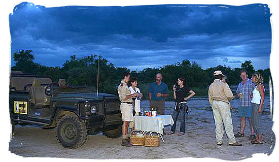 Enjoying sundowners on a game drive in the Mala Mala private game reserve.