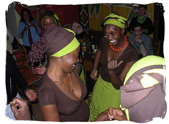 Dancing waitresses at the Africa Café, traditional Africa restaurant in Cape Town - South Africa's Traditional African Food