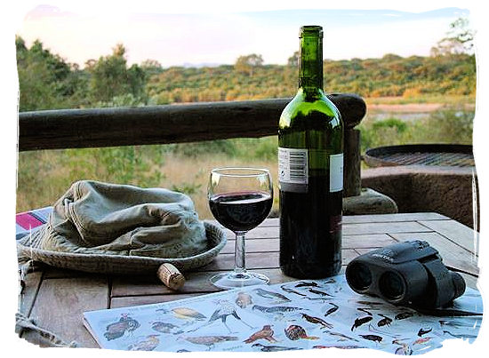 On the deck of one of the semi-luxury Safari tents at rest camp, enjoying a good south African wine - Lower Sabie Rest Camp in the Kruger National Park, South Africa