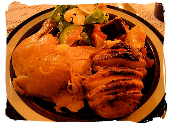 Chicken, baked potato and salads, typical South African home cooking