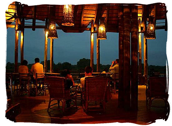Relaxing after dinner on the deck at the camp,s restaurant - Lower Sabie Rest Camp in the Kruger National Park, South Africa
