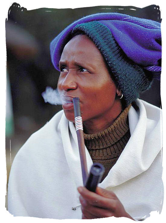 Xhosa lady enjoying her pipe at the lesedi cultural village - Black People in South Africa, Black Population in South Africa