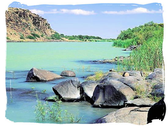 The mighty Orange river flowing wide and slowly below the Vanderkloof Dam