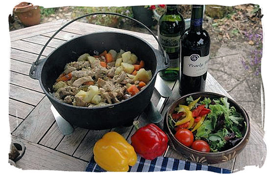 Delicious “Potjiekos” (pot stew), served with salads and accompanied by a good wine - South African traditional food