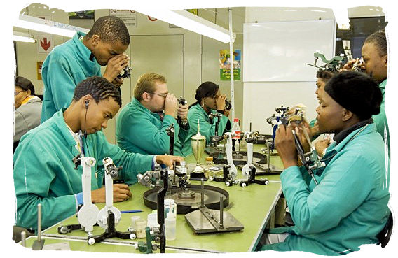 Trainee diamond polishers at the Harry Oppenheimer Diamond training school - South African national anthem