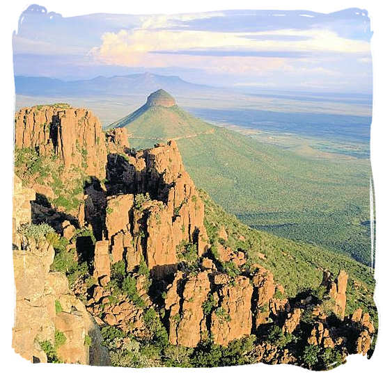 Huge rock columns with Spandou kop (hill) in the background in the valley of desolation - Camdeboo National Park, previously known as the Karoo Nature Reserve