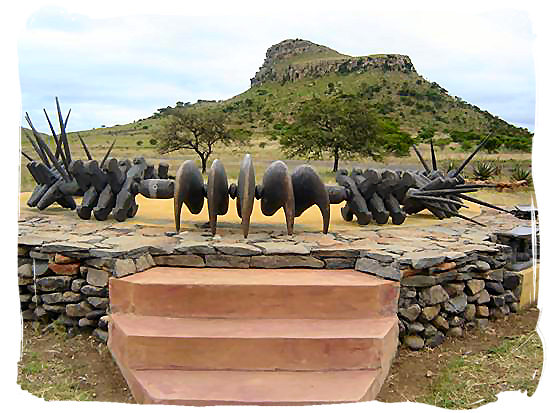 Memorial erected at the site commemorating the fallen Zulu impi at Isandlwana Hill (visible in background)