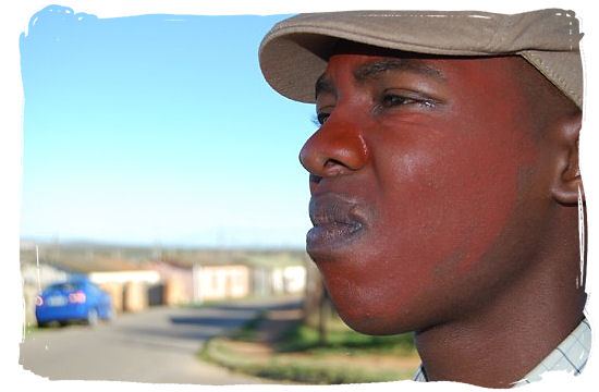 after initiates have passed into Manhood, they smear red clay on their faces to celebrate - Xhosa Tribe, Xhosa Language and Xhosa Culture in South Africa