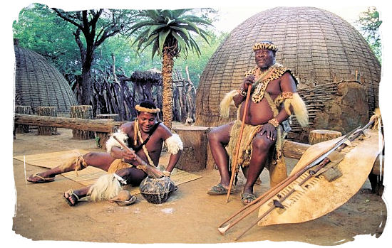 Zulu's in front of hut with weapons at Shakaland cultural museum - Ode to Kwazulu Natal Province, Tourism, South Africa